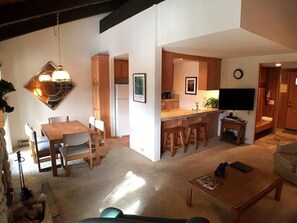 A compact living space with a dining area, kitchen, and seating area.