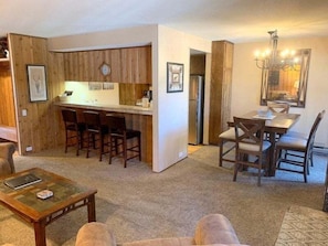 A compact living space with a kitchen, dining area, and seating.