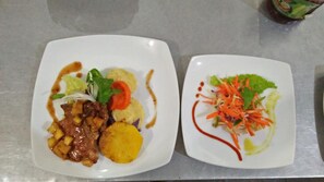 Two square white plates with food on a metallic surface. - khaya villa (Habarana)