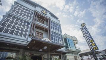 Hotel GBH features a unique blend of modern and traditional architecture with large windows and a balcony area.