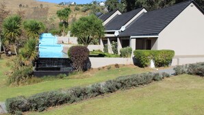 A residential area with modern houses, a swimming pool, and well-maintained landscaping. - Mount Shekinah Country Hotel (Balgowan)