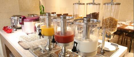 A breakfast bar with various food dispensers, including a smoothie maker, a yogurt dispenser, and a cereal dispenser.