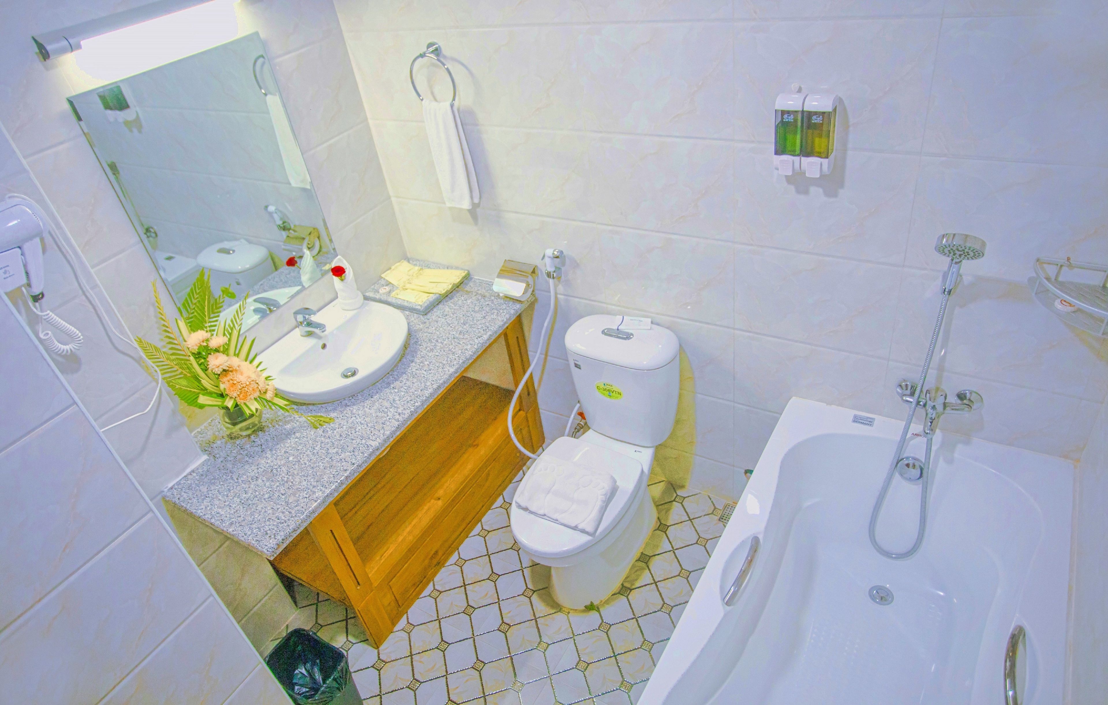 A bathroom with a sink, toilet, and bathtub.