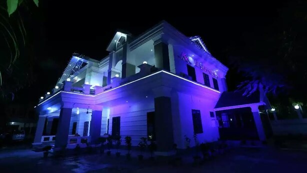 A modern building with a prominent entrance and a sign that reads "All Seasons." - Hotel-All Season Lodge (Sylhet)
