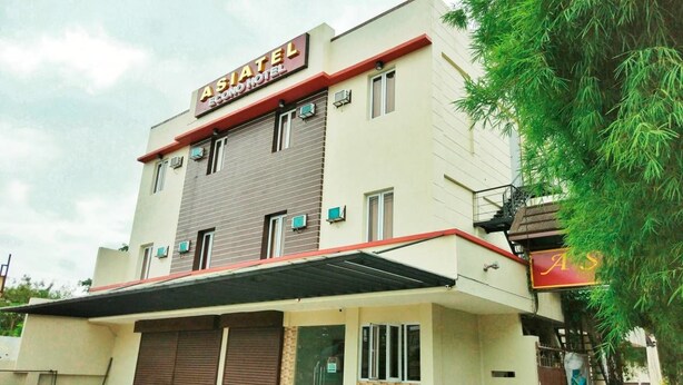 A two-story building with a sign reading "ASIATEL ECO HOTEL". - Asiatel Hotel, Sta. Rosa, Laguna (Santa Rosa)