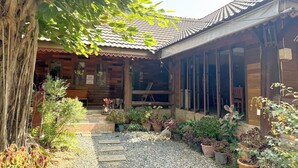 A traditional wooden building with a tiled roof, a covered porch, and a gravel pathway. - The Northern View Hotel (Sung Men)