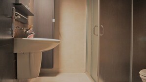 A bathroom with a sink, mirror, and shower enclosure. - Yamsafer Homes 4th Circle (Amman)