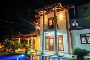 A two-story building with a balcony, columns, and a swimming pool. - Villa Almond Leaf (Hikkaduwa)