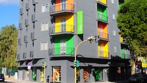 A multi-story building with balconies, a green sign, and a no parking sign. - ibis Styles Brindisi (Brindisi)