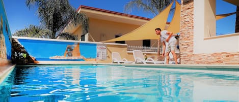 Seasonal outdoor pool, pool umbrellas, pool loungers