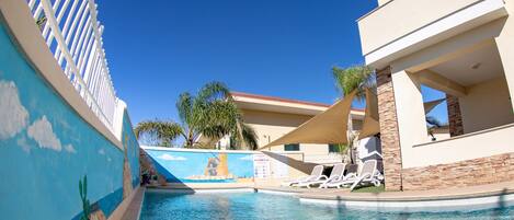 Seasonal outdoor pool, pool umbrellas, pool loungers