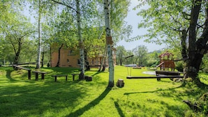 A park with picnic tables, swings, and a playground. - Apartmány Nad Rybníky (Horni Plana)