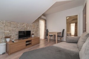 Apartment, 1 Bedroom, Balcony | Living area | Flat-screen TV