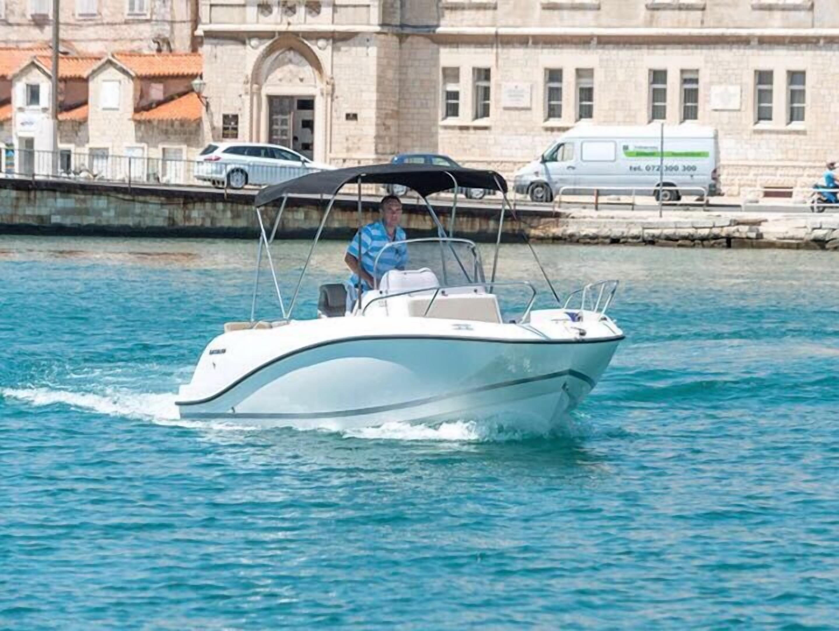 A boat moving on water with a person on board.