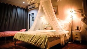 A bedroom with a canopy bed, bedside tables, and a chandelier. - Nego Home (Bangkok)