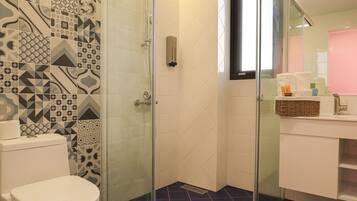 A bathroom with a shower, toilet, and sink.