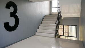 A staircase with a large '3' on the wall, leading to an upper floor. - Villa's Day (Phitsanulok)