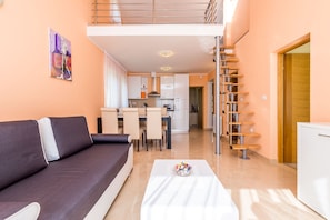 A modern apartment with a living area, kitchenette, and a staircase. - Luxury Apartments Kostrena (Kostrena)