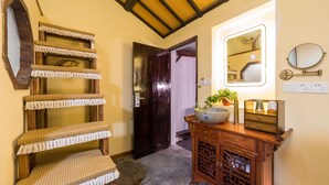A hallway with a wooden staircase, a mirror, a cabinet with decorative items, and a door leading to another room. - Hemu Shantang Street (Suzhou)