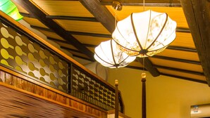 A traditional Japanese-style room with a wooden door, a shower, a decorative shelf, and a hanging light fixture. - Hemu Shantang Street (Suzhou)