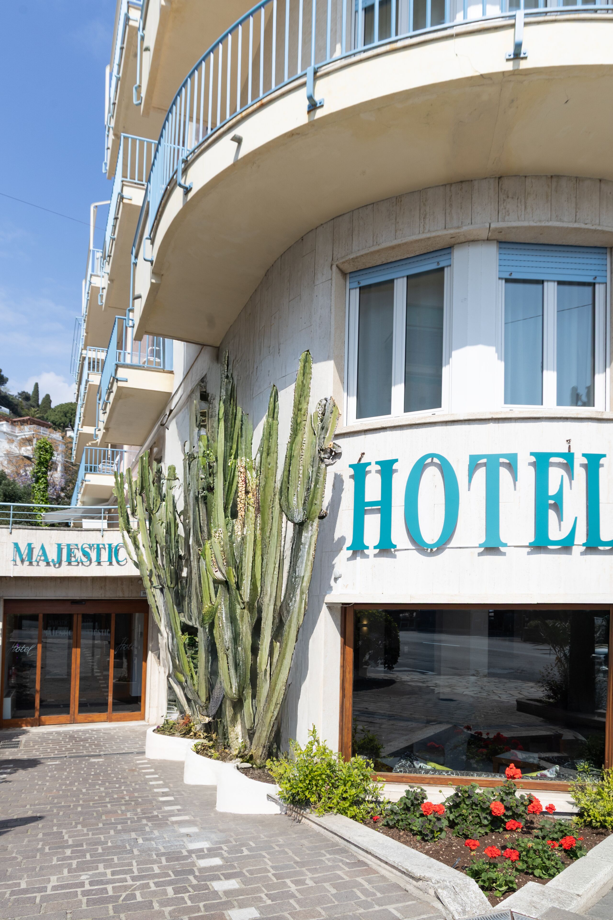 Un hotel con fachada curva, un balcón y un letrero que dice "HOTEL".