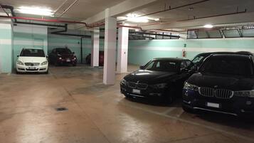 A multi-level parking garage with concrete floors and white pillars.