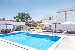 Seasonal outdoor pool, open 9:00 AM to 8:00 PM, pool loungers