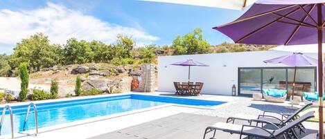 Seasonal outdoor pool, open 9:00 AM to 8:00 PM, pool loungers