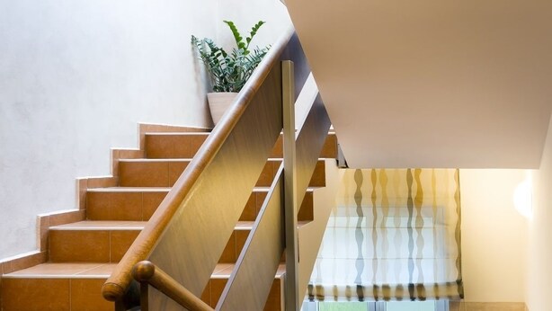 A staircase with wooden handrails and a potted plant at the top. - Pension Bed & Breakfast (Kutna Hora)