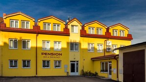A yellow building with the sign "PENSION Bed & Breakfast" indicating it offers lodging and breakfast services. - Pension Bed & Breakfast (Kutna Hora)
