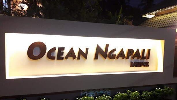 A sign for Ocean Ngapali Lodge with a modern design and illuminated letters. - Ocean Ngapali Lodge (Ngapali)