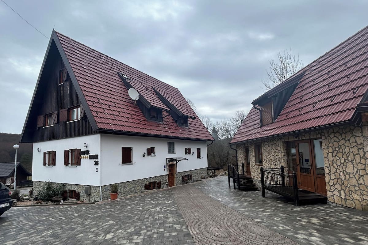 A building with a sloped roof and a satellite dish.