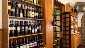 A wine cellar with shelves of wine bottles. - Albergo Ristorante Poli (San Benedetto Val di Sambro)
