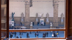 A view of a public square with statues and arches. - Signoria Farine (Florence)