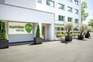 A modern hotel with a sign reading "number one hotel."