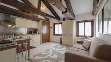 Apartment, 1 Bedroom, Smeraldo | Living area | Flat-screen TV
