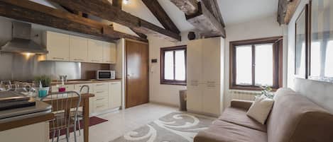 Apartment, 1 Bedroom, Smeraldo | Living area | Flat-screen TV