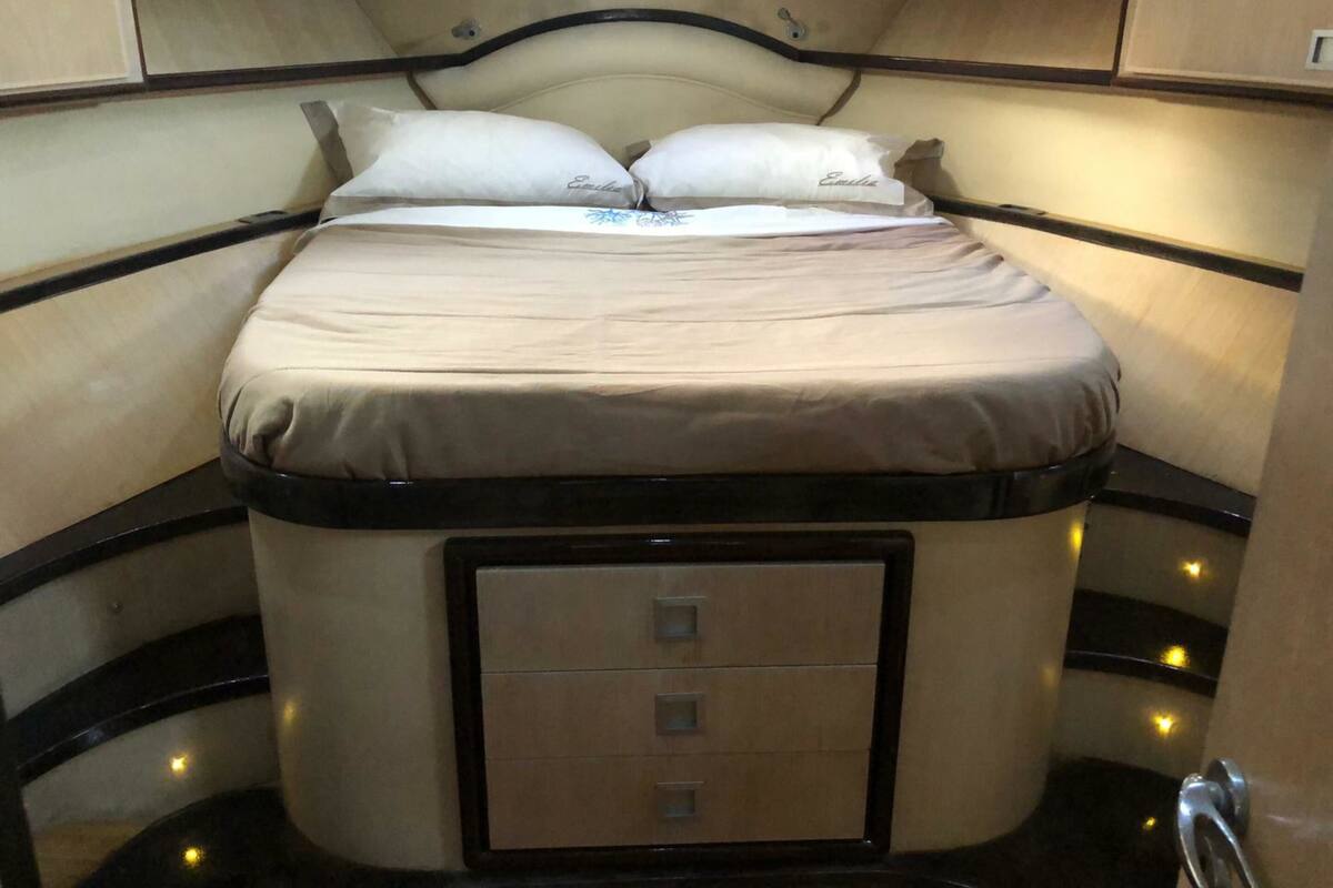 A compact bed with a headboard and a storage drawer underneath.