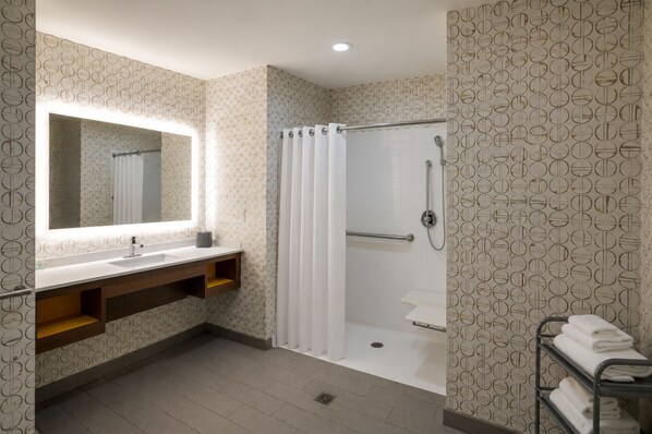 A modern bathroom with a shower, a sink, and a mirror. - Holiday Inn & Suites Memphis Southeast-Germantown by IHG (Memphis)