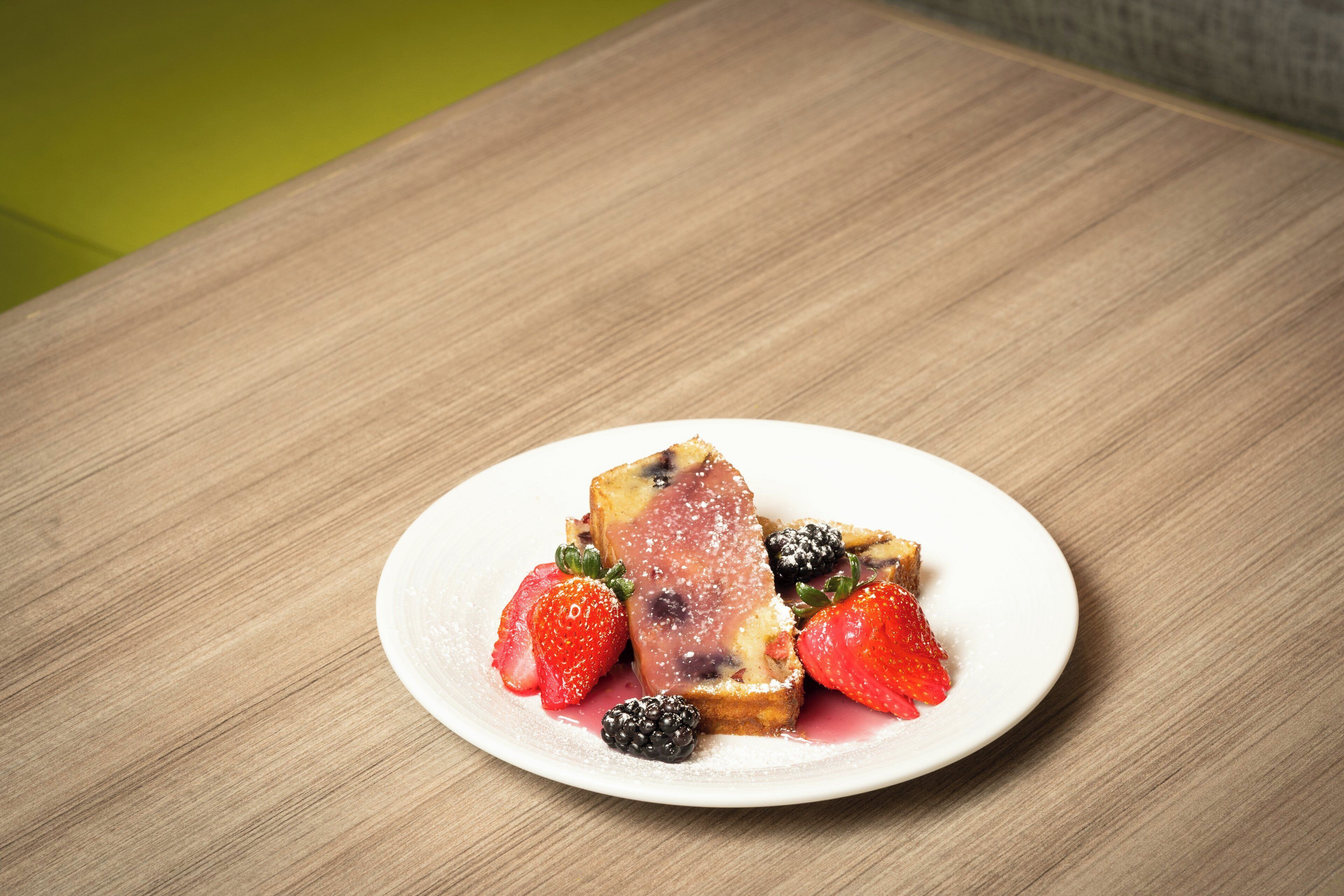 A plate with a dessert on a wooden table.
