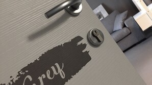 A door with a keyhole and a lock, and a label that reads "Grey". - Art B&B Design (Costa Volpino)