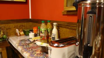 A kitchen counter with a toaster, a blender, and various bottles and containers.