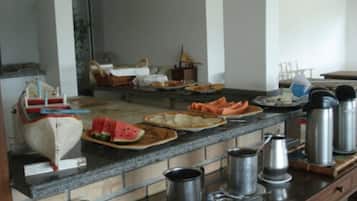 A kitchen counter with various food items and kitchenware.
