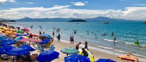 On the beach, sun-loungers, beach umbrellas, beach towels