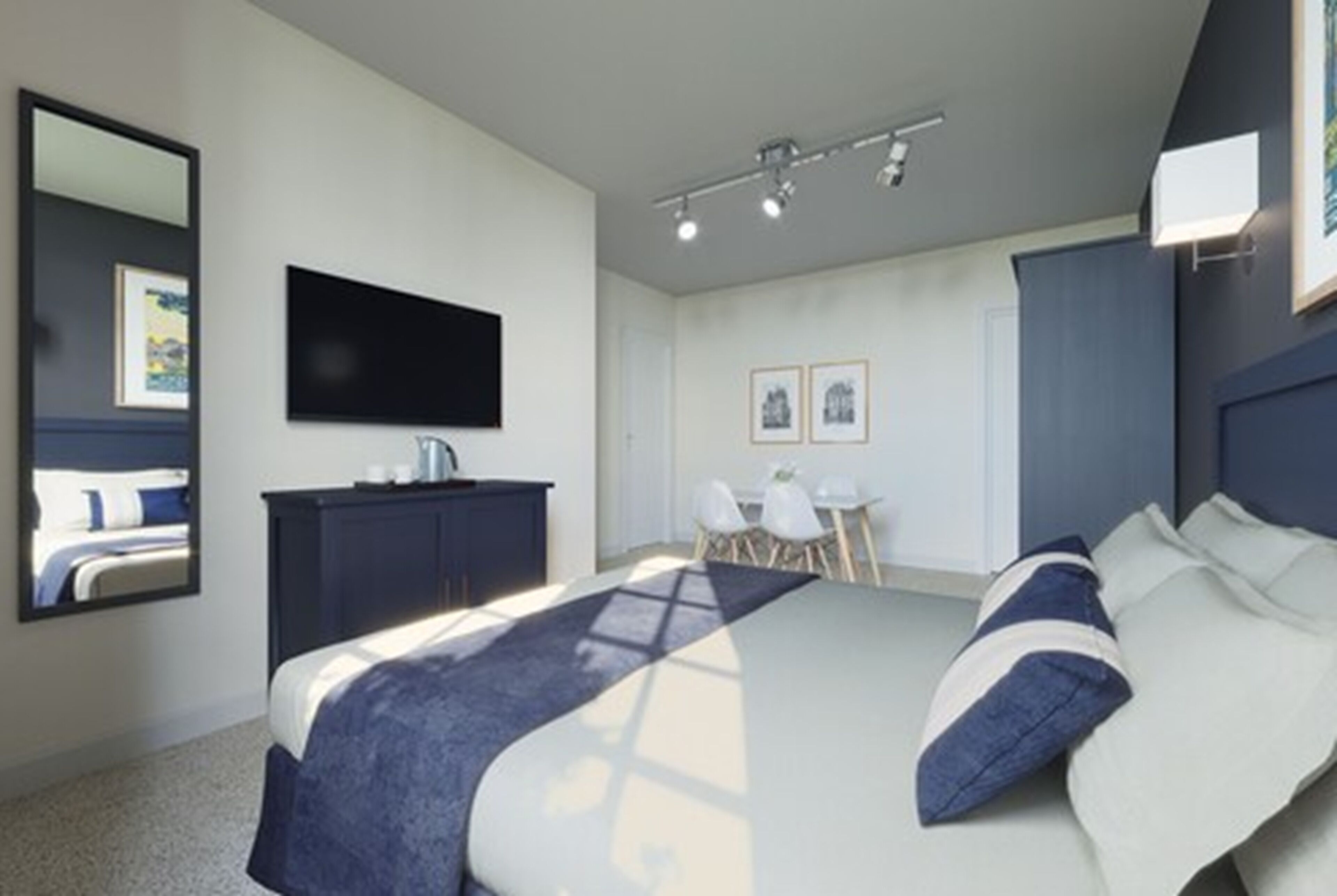 A modern bedroom with a large bed, a desk, and a chair.