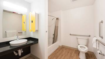 A modern bathroom with a sink, mirror, and toilet.