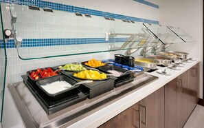 A buffet with various food options including fruits, yogurt, and other dishes. - Hilton Garden Inn Boise Downtown (Boise)