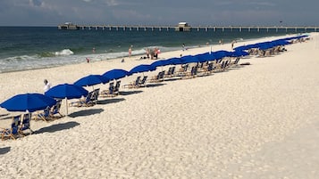 On the beach, white sand, sun loungers, beach umbrellas