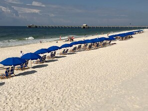 On the beach, white sand, sun loungers, beach umbrellas