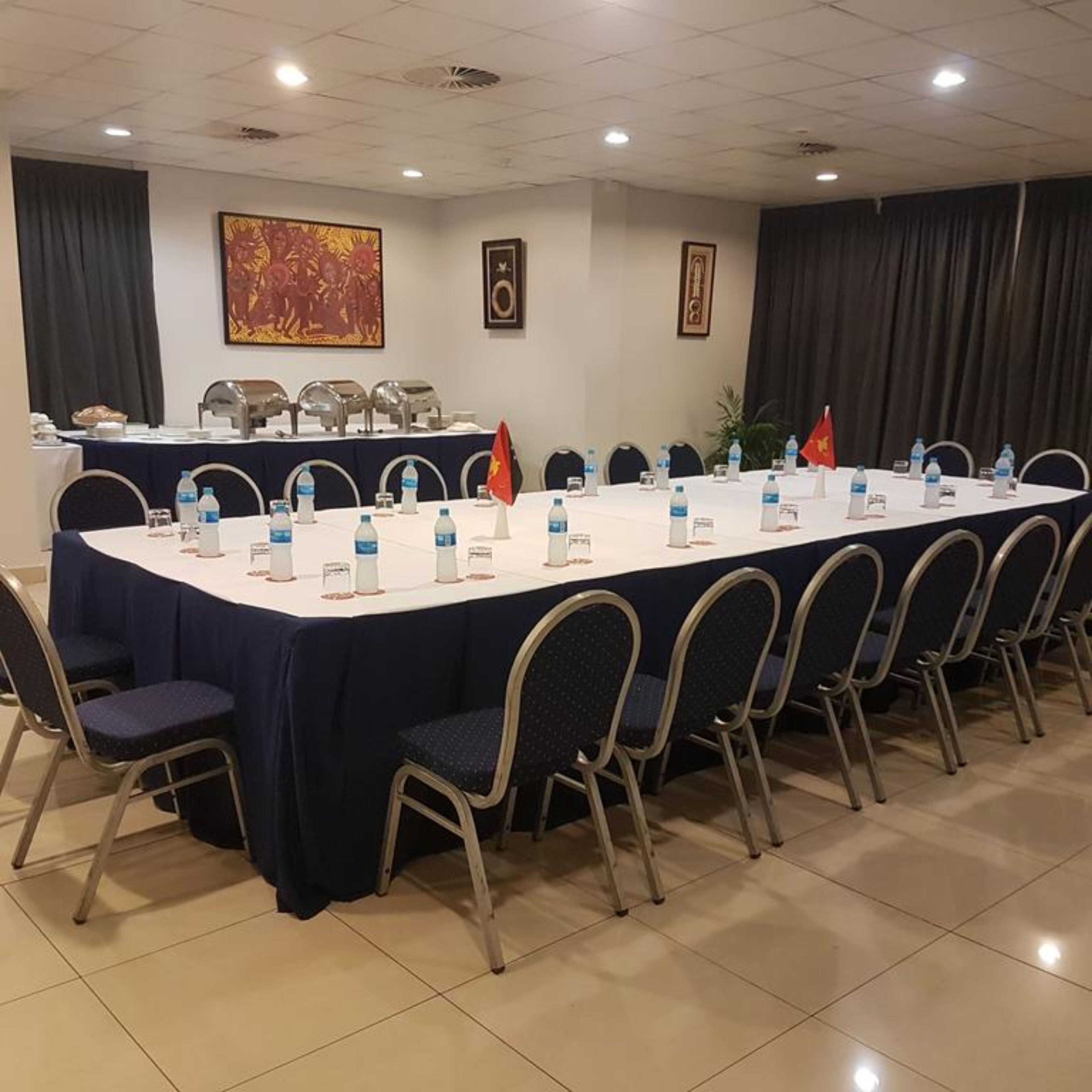 A conference room with a long table, chairs, and nameplates.